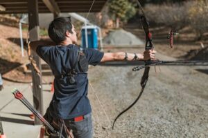 Man shooting compound bow